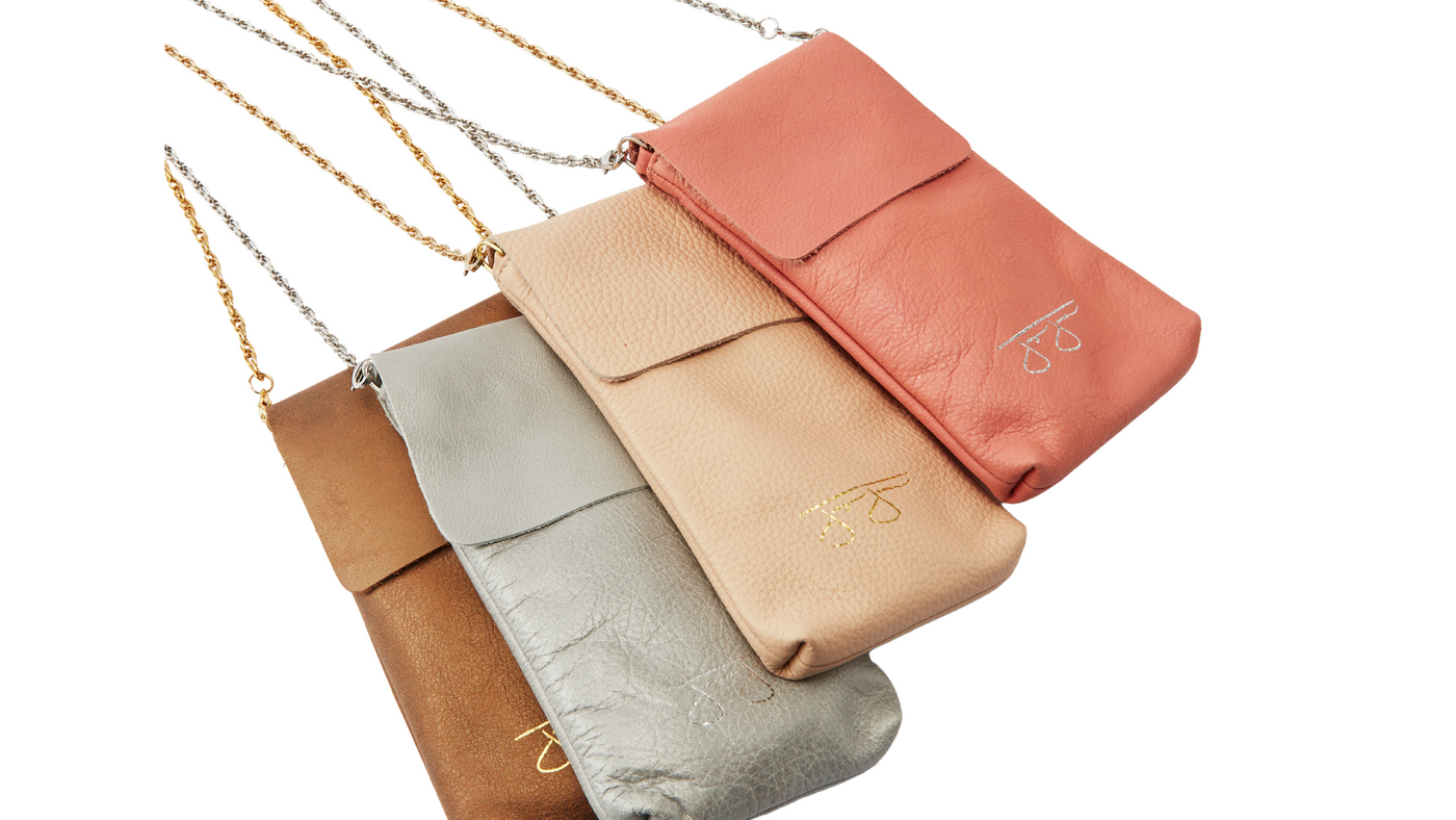 a collection of neutral color italian leather purses and wallets